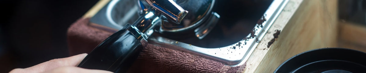 Coffee grounds being emptied into a counter top knock box